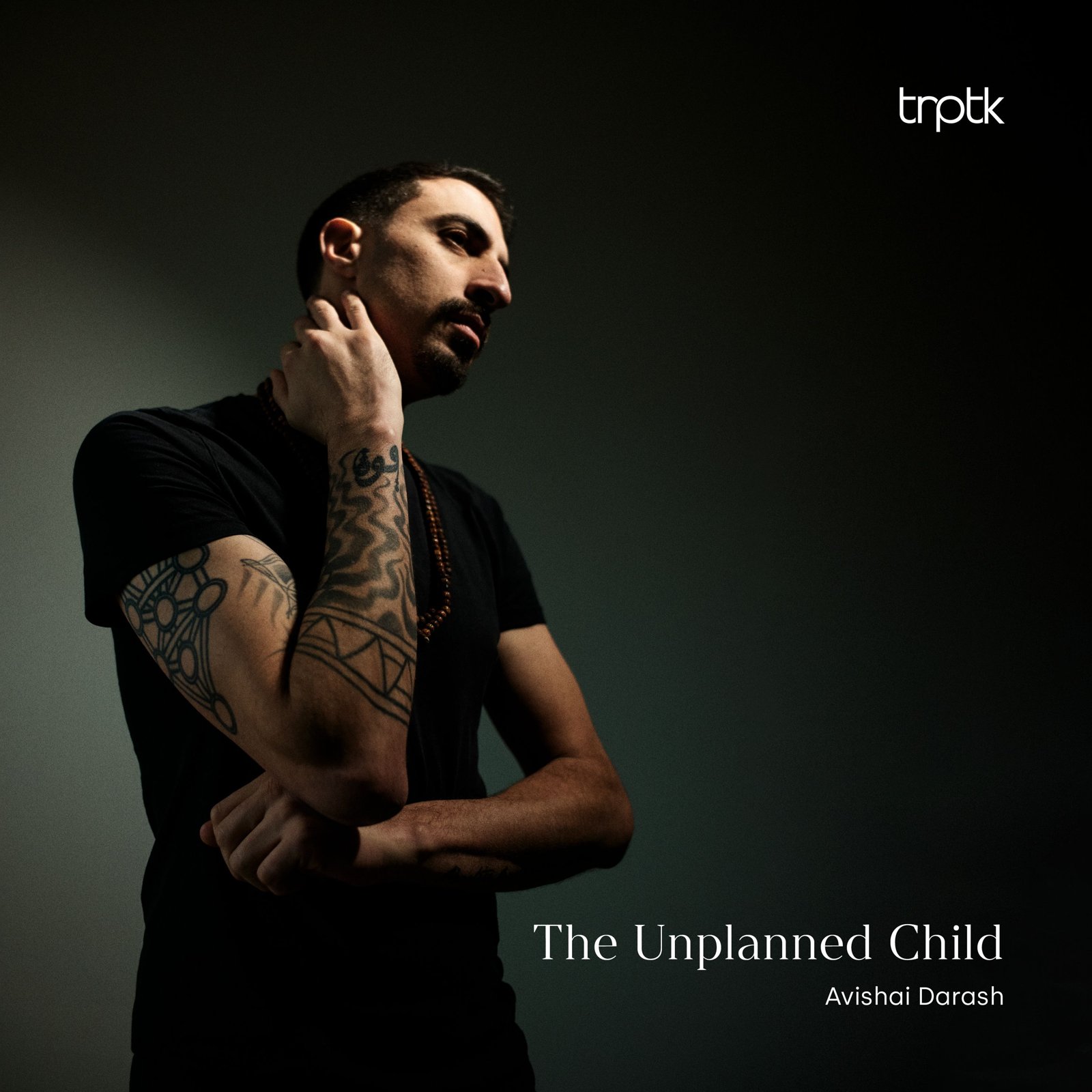 The Unplanned Child album cover: Avishai Darash in a dark room, hand at his neck